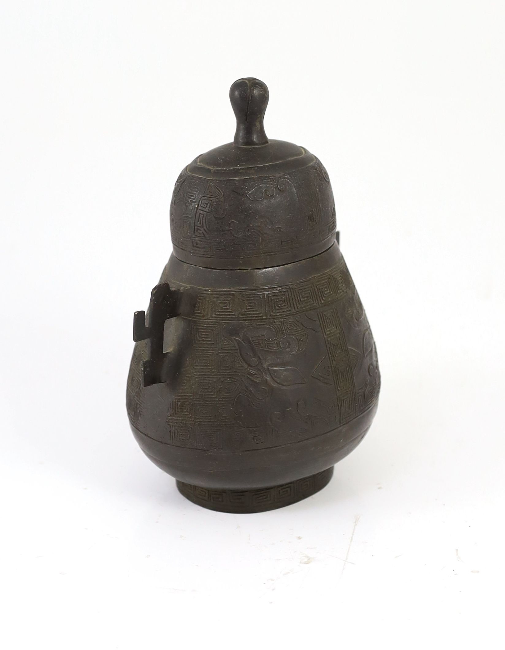 A Chinese bronze jar and cover, hu, 17th/18th century, 18cm high, losses to handles